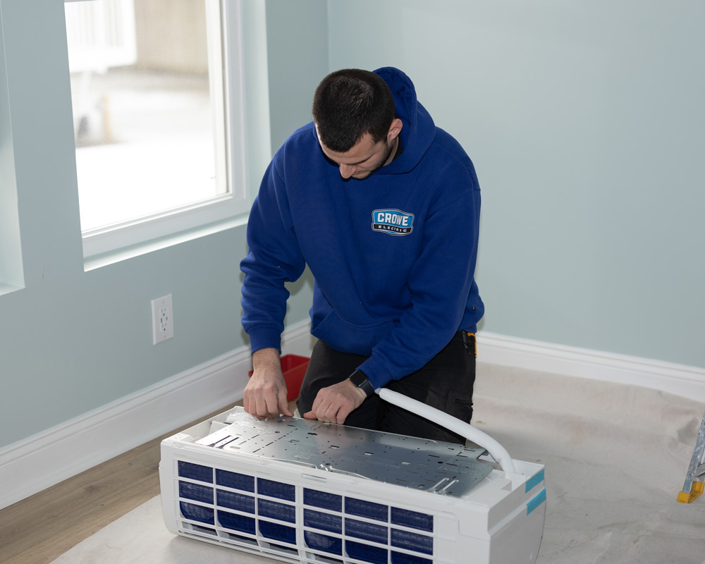 Electrician inspecting a portable AC unit