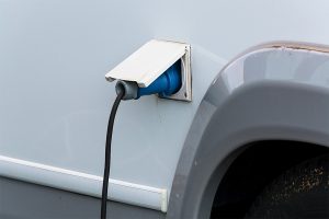 Electric vehicle charging port connected to a power cable